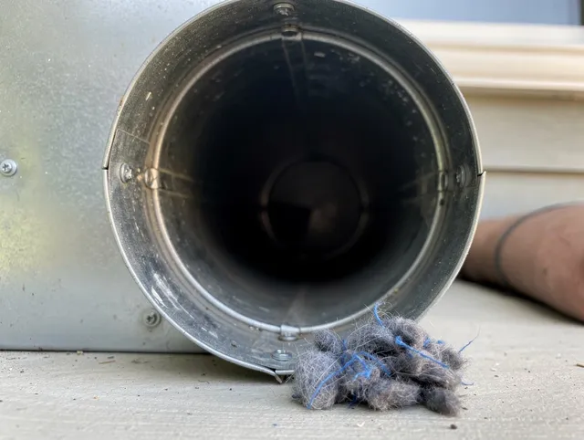 Apopka Dryer Vent Cleaning technician using specialized equipment to clear severe dryer vent blockage in Apopka